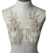 Cream colored 3D flowers appliqués with gold stitching