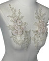 Cream colored 3D flowers appliqués with gold stitching