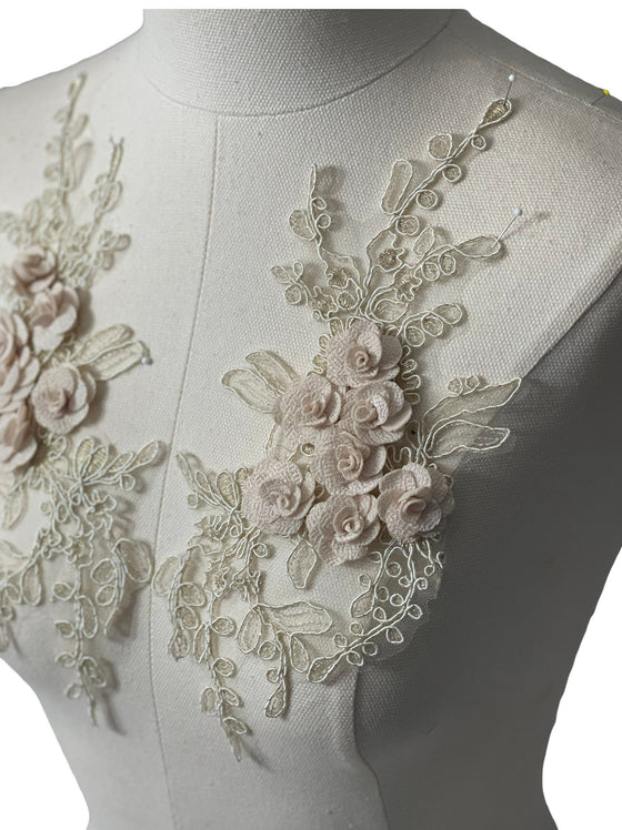 Cream colored 3D flowers appliqués with gold stitching